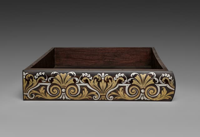 A drawer, alone, out of its cabinet. Dovetails you were never meant to see. The best part of the piece.