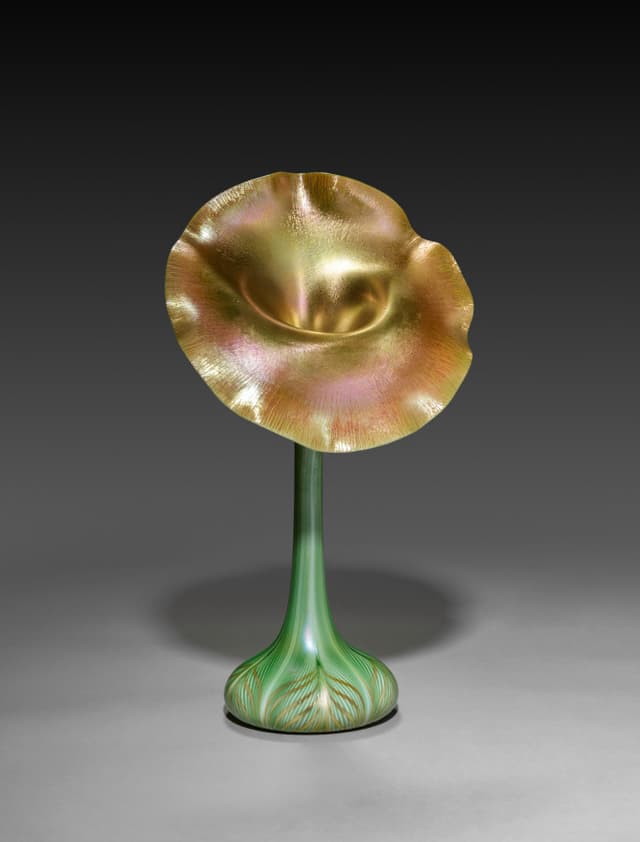Iridescent glass: the colour isn't in the material, it's in the angle. That's a shader, 1900.