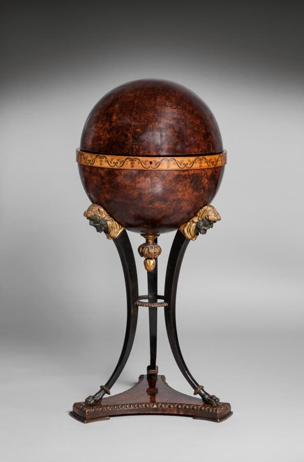 A globe that opens into a work table. One object, two states. The best objects have two states.