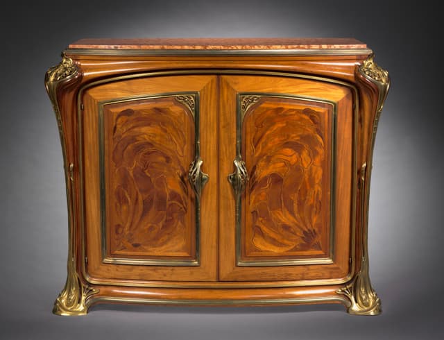 Majorelle: the mahogany curves where the hand goes. Follow the hands and the form draws itself.